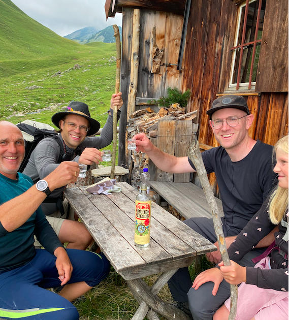 Martin serves us schnapps  outside his small hut in the Alps