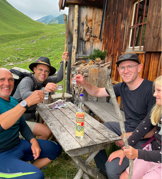 Martin serves us schnapps outside his small hut in the Alps