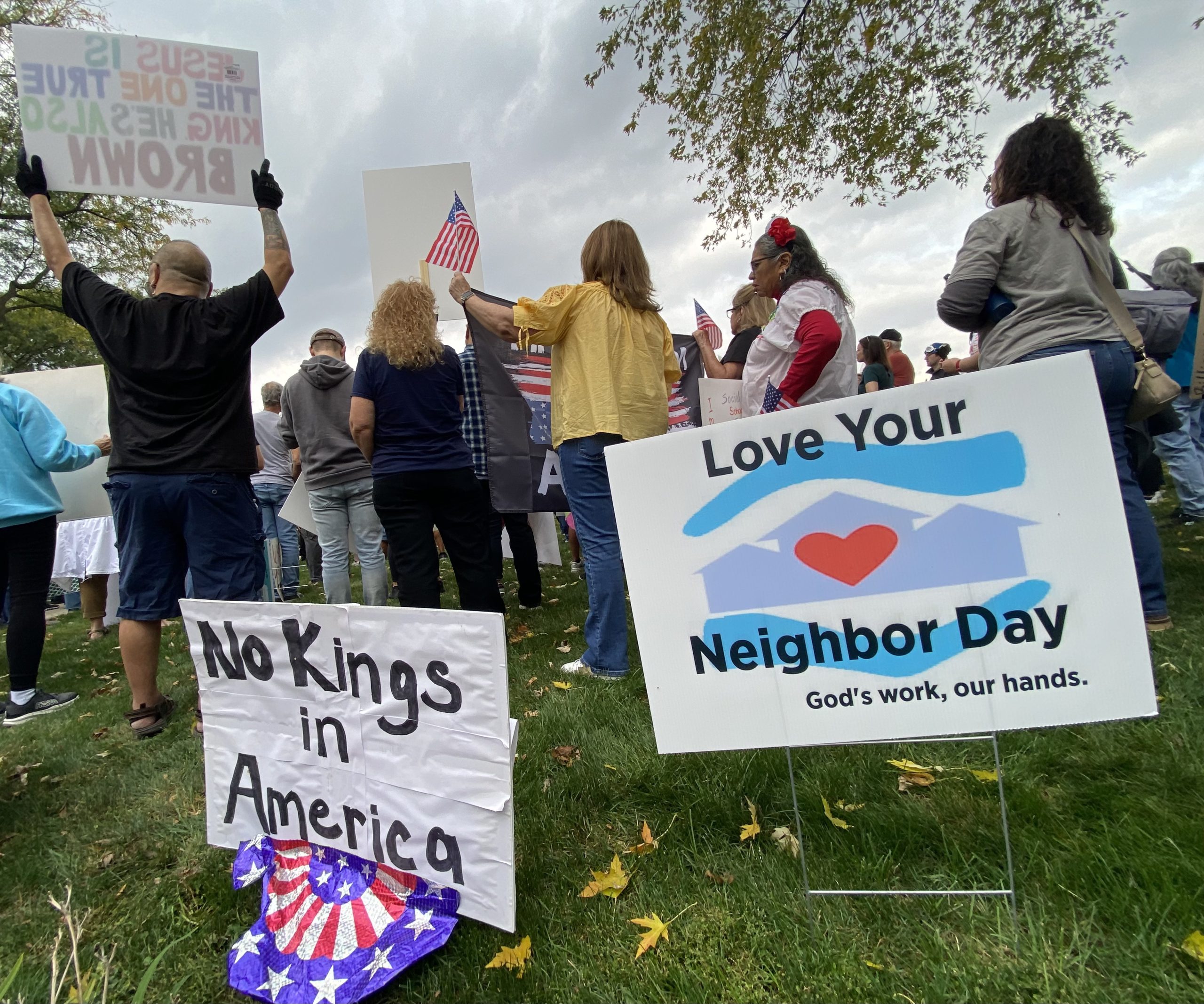 Signs from the No Kings protest on October 18, 2025 demand us to love our neighbors as ourselves