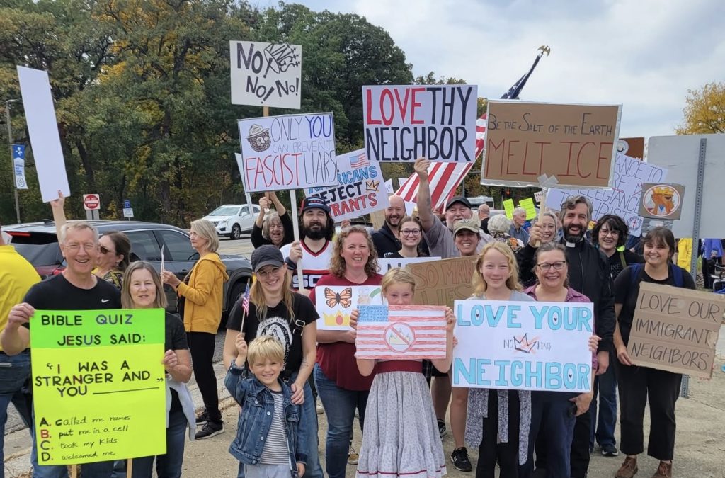 Signs from the No Kings protest on October 18, 2025 demand us to love our neighbors as ourselves